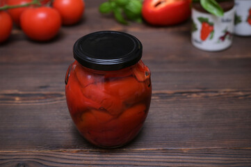 canned red paprika homemade preparations on a wooden table closeup