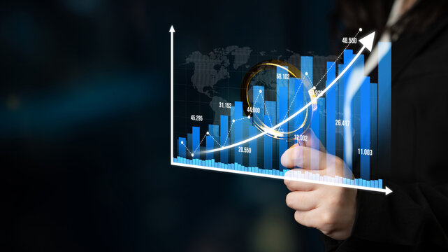A businessperson inspects data trends using a magnifying glass over a bar graph set against a world map backdrop, highlighting careful analysis in a professional atmosphere. Tessel
