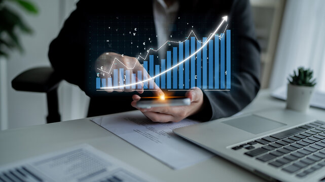 A business professional interacts with a smartphone to analyze financial market trends, featuring growth charts and statistics in a modern office environment. Impute - Powered by Adobe