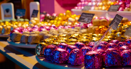 Vibrant wrapped candies gleaming on display plates, showcasing colorful confectionery delicacies...