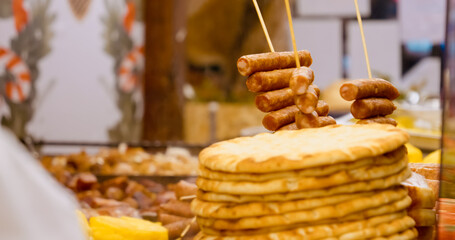 Explore a vibrant display of sausages and various meats in a store window, perfect for holiday feasts and cooking inspiration for meat lovers.