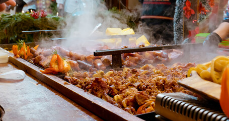 Explore a festive meat display featuring assorted sausages and pork products. This vibrant window showcases holiday cooking favorites and tantalizing aromas.