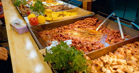 Experience the lively atmosphere of a Christmas market, featuring an array of authentic Romanian foods like sausage, pork, polenta, and seasonal delights to savor.