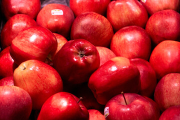 fresh red apples neatly arranged on a supermarket shelf. vibrant, juicy fruits symbolizing health, freshness, and natural food. perfect for illustrating concepts of grocery shopping, healthy eating, a