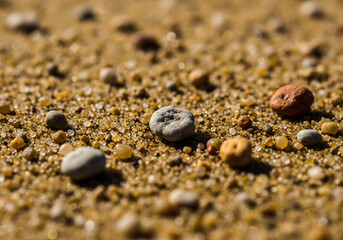Golden Desert Sandscape A Captivating Macro View of Colorful Pebbles Scattered Across a Sandy Expanse