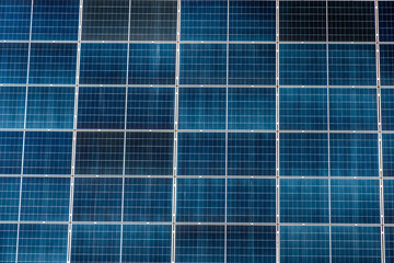 Solar panels arranged in a grid pattern capture sunlight for energy generation in a clean, renewable setup