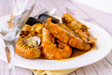 Traditional Catalan fish stew romesco de peix with prawns, mussels and fish as top view
