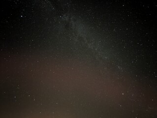 A breathtaking view of the night sky filled with countless stars, showcasing the majestic Milky Way galaxy. The deep dark sky is peppered with starlight.