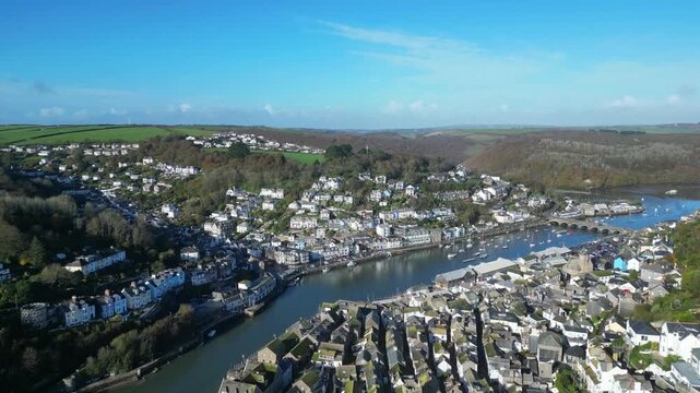 
Looe, Cornwall, England: DRONE VIEWS: The drone flies over the town of Looe towards the East Looe river. Looe is an ancient fishing port and popular UK holiday destination.