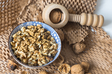 Cracking Walnuts with a Traditional Wooden Nutcracker on a Recycled Paper Background