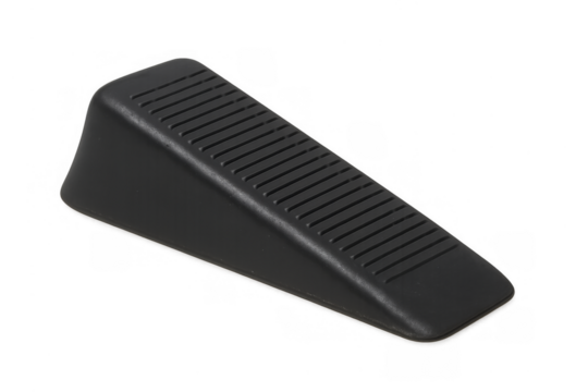 Black rubber wedge doorstopper securing open door - Powered by Adobe
