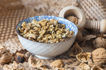 Cracking Walnuts with a Traditional Wooden Nutcracker on a Recycled Paper Background