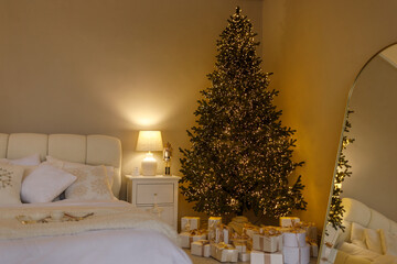 Cozy bedroom interior with warm fairy lights, soft pillows, and a cup of coffee on a tray. Relaxing winter morning or holiday atmosphere in a comfortable home setting