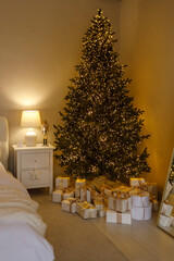 Cozy bedroom interior with warm fairy lights, soft pillows, and a cup of coffee on a tray. Relaxing winter morning or holiday atmosphere in a comfortable home setting