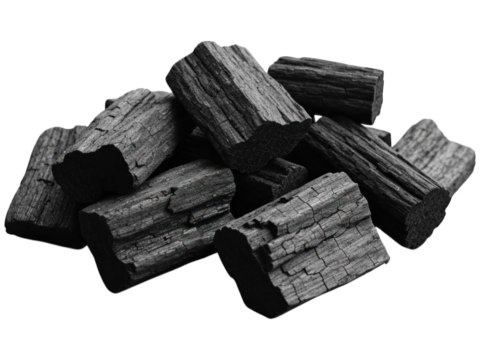 A grayscale close-up of a pile of charcoal briquettes, showing wood grain textures