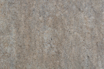 full frame closeup of a grainy light taupe sandstone or limestone floor showing fine textured surface for architecture, geology, and concept of natural stone materials