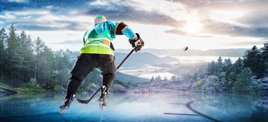 Hockey players in action on the ice. Outdoor game. Sports. Hockey match. A large hockey rink in the middle of an forest. Hockey concept. Panorama