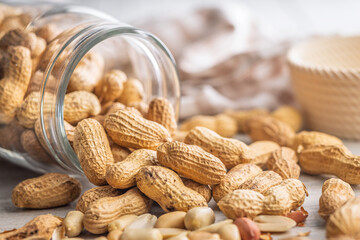 Peanuts in shell. Groundnuts in jar on kitchen table.