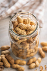Peanuts in shell. Groundnuts in jar on kitchen table.