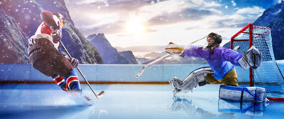 Hockey players in action on the ice. Outdoor game. Sports. Hockey match. A large hockey rink in the middle of an forest. Hockey concept. Panorama