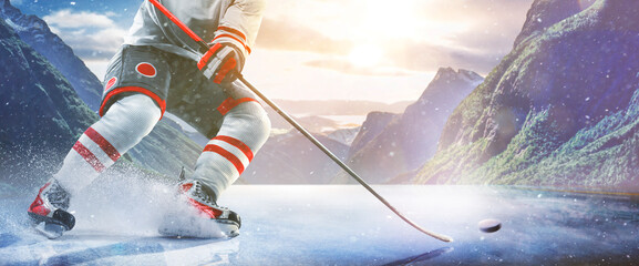 Hockey players in action on the ice. Outdoor game. Sports. Hockey match. A large hockey rink in the middle of an forest. Hockey concept. Panorama