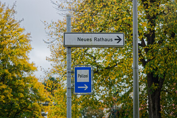 Direction sign to police and new town hall with arrows right in german language