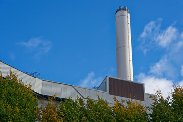 Stadtwerke Flensburg Industrial plant wall with tall white chimney stack view