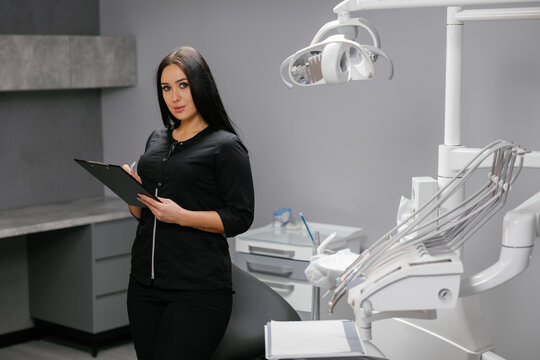 Woman dentist updating patients medical records