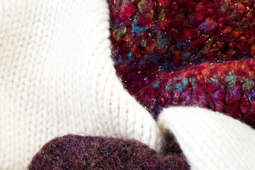 Knitted woolen sweaters. A bunch of knitted winter, autumn clothes, sweaters, knitwear, space for the text.