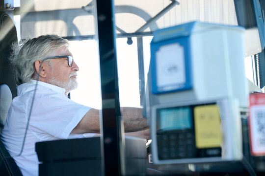 Senior bus driver working on public transport route