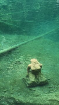 Underwater rock formation in clear turquoise water at Blausee Lake, Switzerland