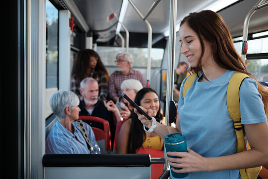 Woman commuting on public bus using smartphone