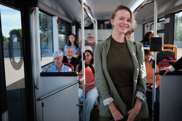 Woman smiling while commuting on a public bus