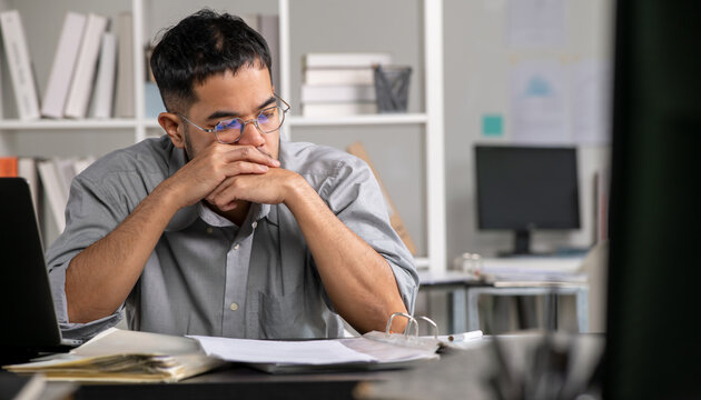Businessman looking stressed from work, Businessman working at office feels overworked and burnout