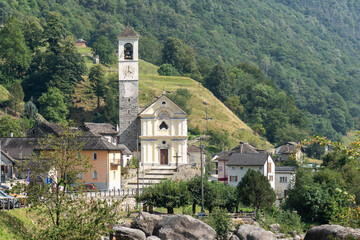 Lavertezzo, Switzerland - August 14, 2025: Beautiful village Lavertezzo and the crystal clear and calm waters of the Verzasca stream. A popular tourist destination in Ticino, Switzerland.