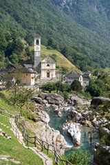 Lavertezzo, Switzerland - August 14, 2025: Beautiful village Lavertezzo and the crystal clear and calm waters of the Verzasca stream. A popular tourist destination in Ticino, Switzerland.