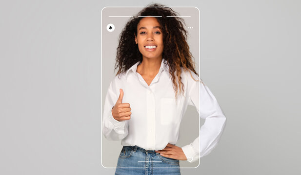 A woman with curly hair smiles and gives a thumbs up while wearing a white shirt. She is posing confidently in a modern and minimalistic space, radiating positivity and joy.