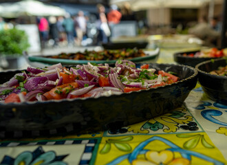 Fresh Italian salad served outdoors at a lively European market scene