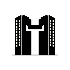 Two buildings connected by a sign form a letter T shape.