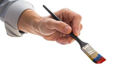 Close up of a hand holding a paint brush, with colorful paint on the bristles ready to create art