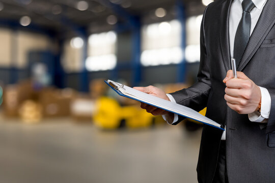 Businessman reviews warehousing.