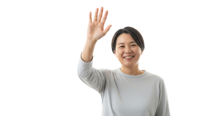Smiling asian woman waving hand, conveying warmth and friendliness in a simple and welcoming gesture of greeting