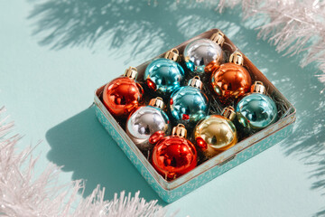 Christmas baubles in pastel and gold tones placed in box