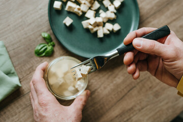 Top view of preparing tofu on wooden background