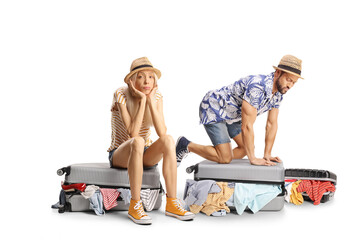 Man and woman packing suitcases