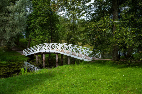 Scenic View of a White Bridge in a Lush Green Park. - Powered by Adobe