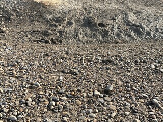 Gravel and small rocks forming a rough outdoor surface with natural earth tones and rugged detail.