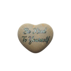 A heart shaped stone with message of kindness and self care reminder