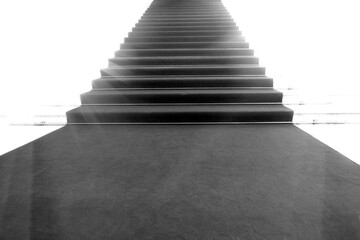 Staircase with red carpet, illuminated by light