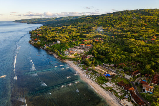 Scenic view of tropical island coastline with jungle, beach, and sea in Indonesia